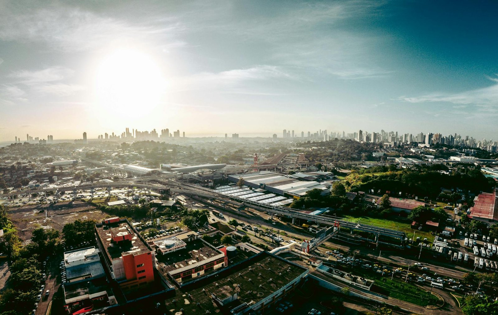 Expansive aerial cityscape of San Miguelito in Panama, featuring urban landscapes and sunlight.
