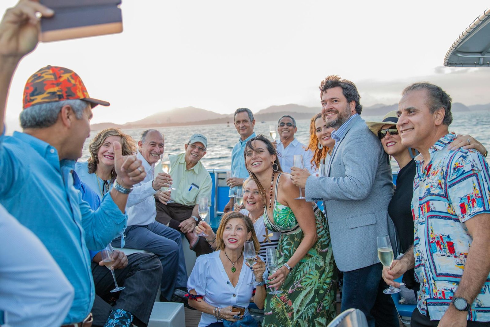 A lively group of adults celebrating on a yacht enjoying a scenic view in Panama.