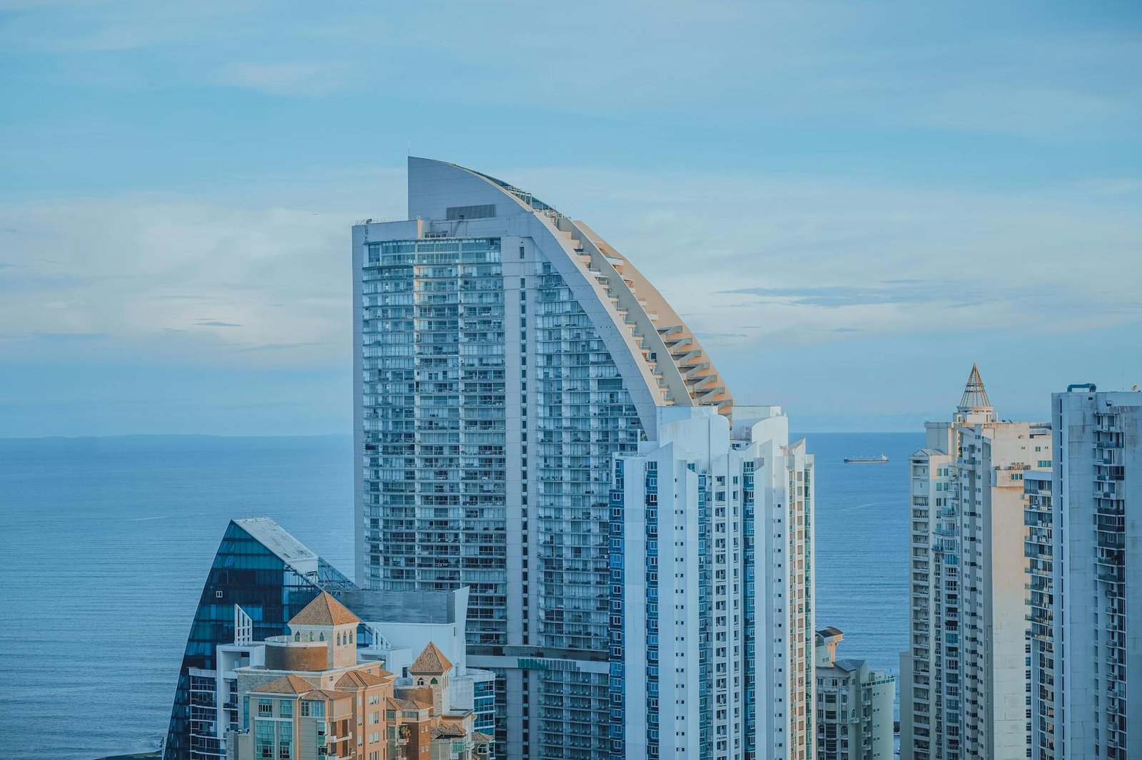 A beautiful view of Panama City's skyline featuring modern high-rise buildings against a blue ocean backdrop.