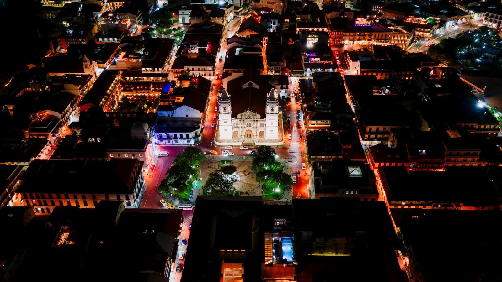 Captivating aerial view of Panama City's vibrant center illuminated at night.