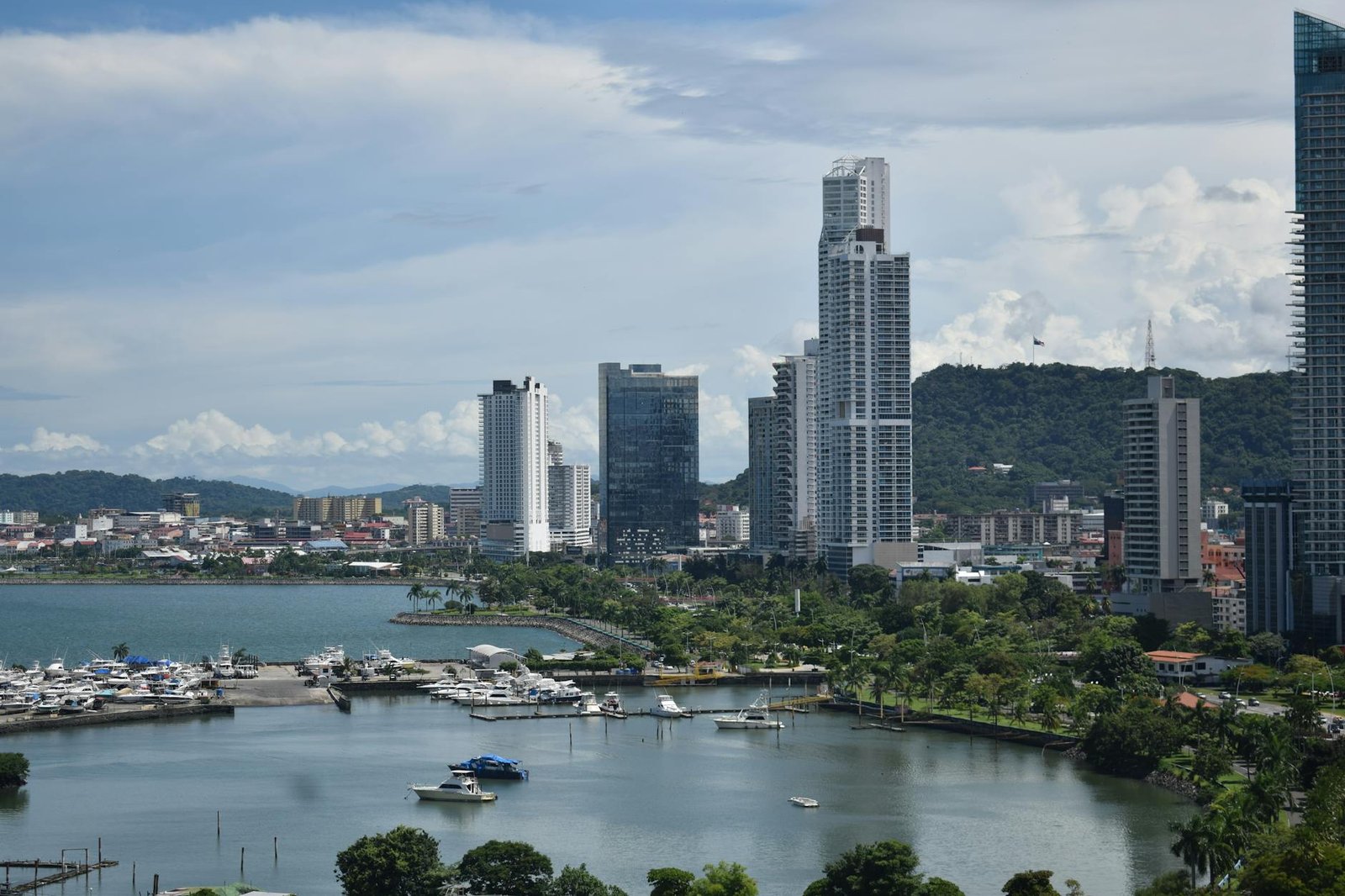 Panama City's modern skyline with marina and lush greenery, a perfect blend of urban and natural beauty.