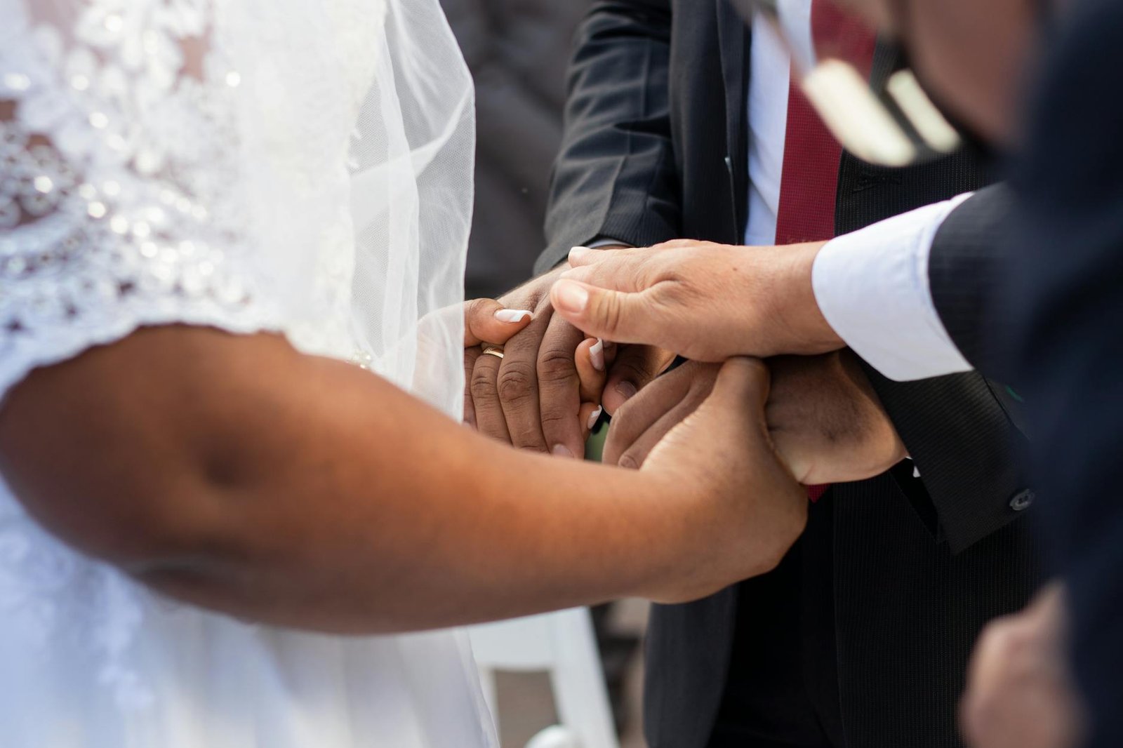 Close-up of hands during a wedding ceremony in Panama, showcasing love and connection.