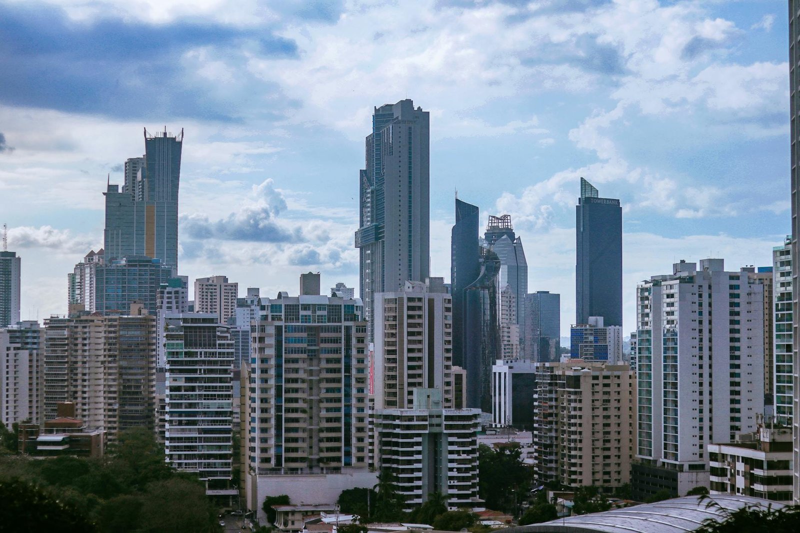 Panama City's modern skyline with towering skyscrapers under a partly cloudy sky.