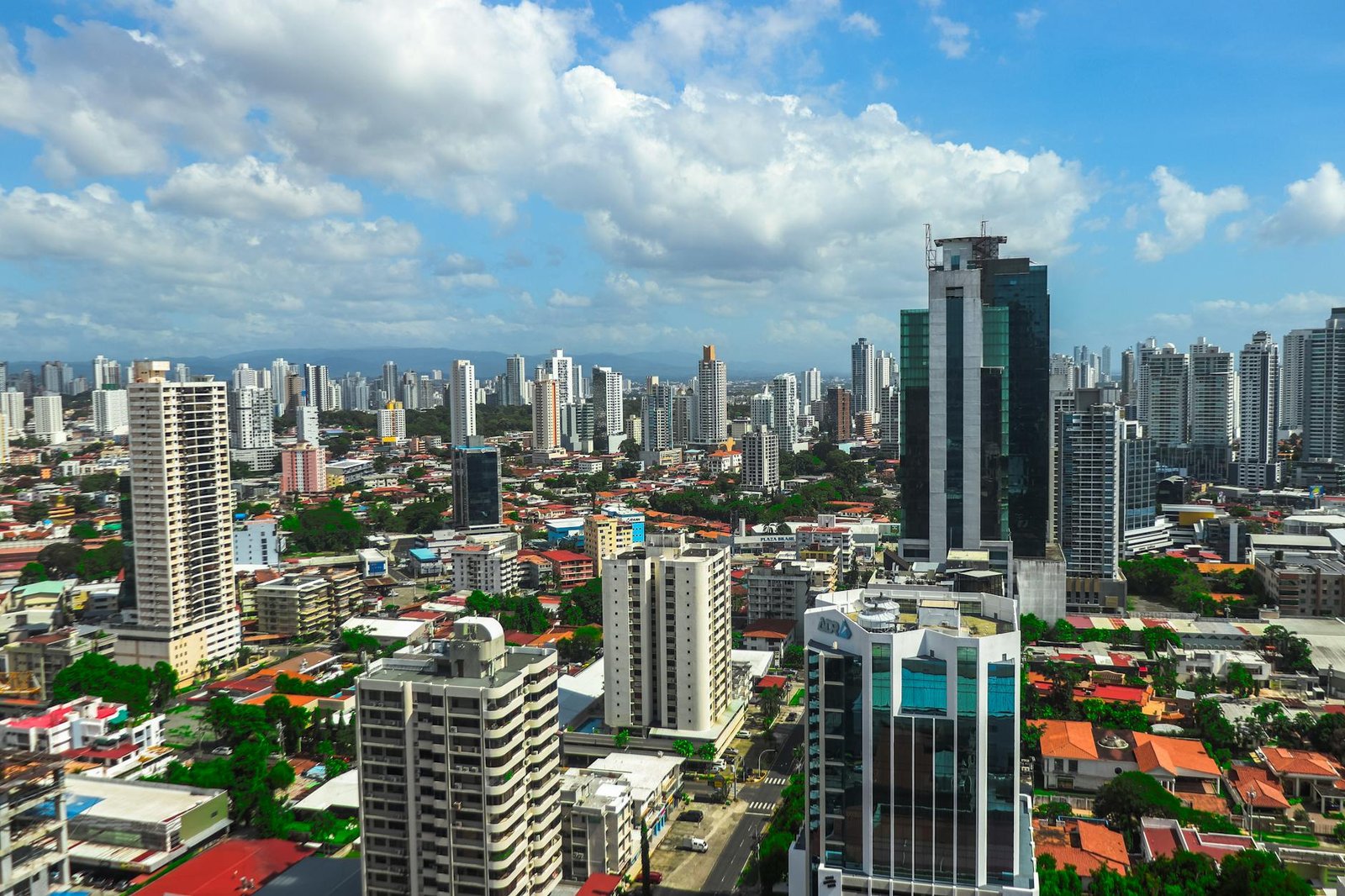 Panoramic view of Panama city's vibrant skyline showcasing modern skyscrapers against a bright sky.